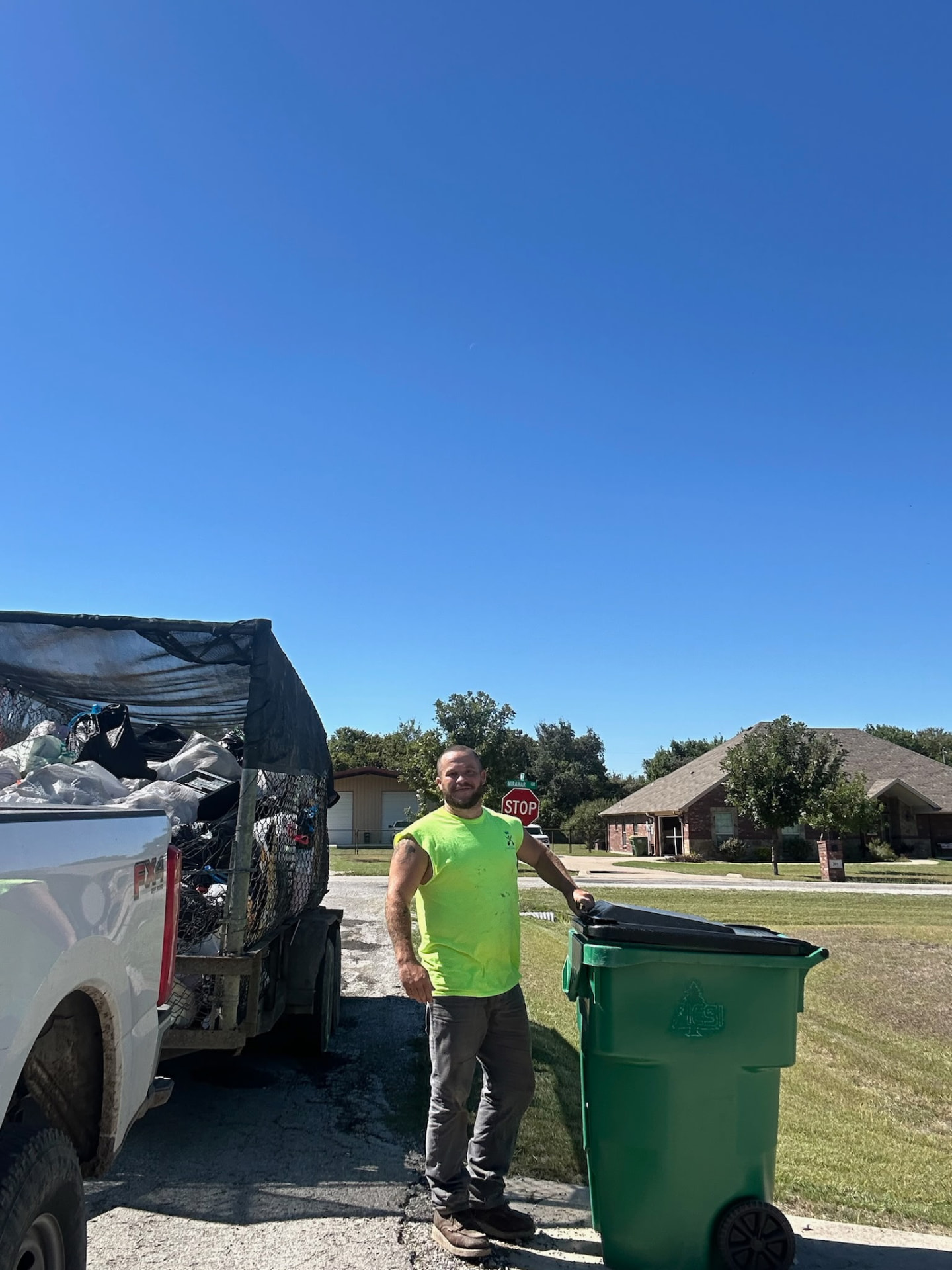 Atex Trash team member with a residential cart and collection truck